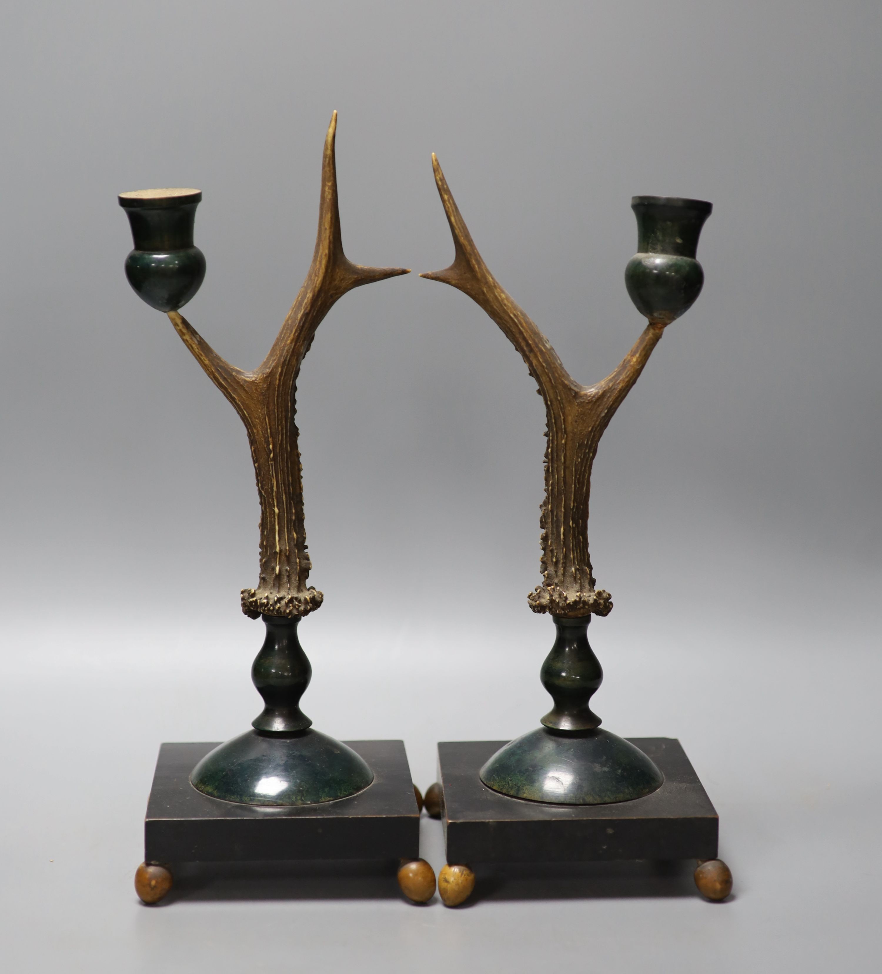 A pair of late 19th/early 20th century antler candlesticks, 34.5cm